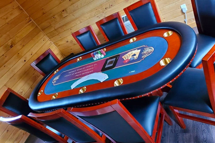Rockwell Poker Table, Black Vinyl Armrest, Brass Cupholders, Deckmate Card Shuffler, and Custom Graphics Playing Surface. Show With Mahogany Dining Chairs.