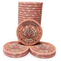 A set of pink and gold Gatsby Room casino-style ceramic poker chips. with one chip in the center displaying the text 'GATSBY ROOM' and '$5000' on a white background.