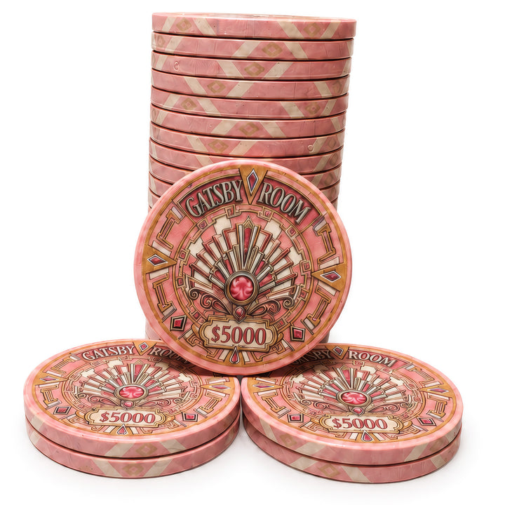 A set of pink and gold Gatsby Room casino-style ceramic poker chips. with one chip in the center displaying the text 'GATSBY ROOM' and '$5000' on a white background.