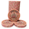 A set of pink and gold Gatsby Room casino-style ceramic poker chips. with one chip in the center displaying the text 'GATSBY ROOM' and '$5000' on a white background.