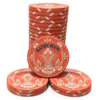A set of orange $1000 ceramic gaming chips for 'Gatsby Room' arranged with one standing in a stack and three placed in front on a white background.