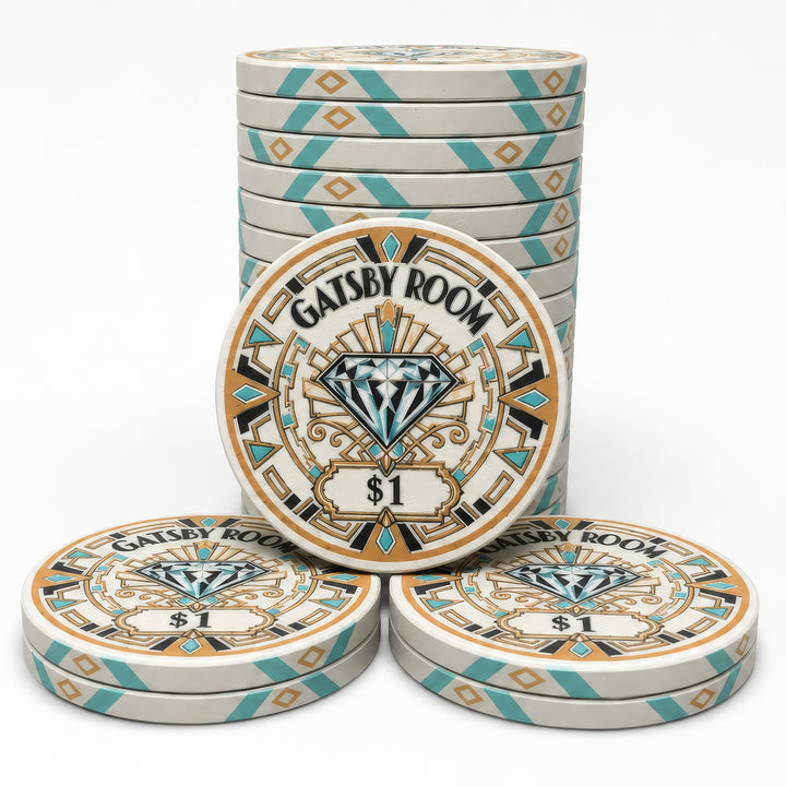 A set of Gatsby Room casino-style ceramic poker chips on a clean white background, featuring a stack of round chips in the back, one chip in the front center, and two chips in the front row. The chips have a cream base with teal and gold geometric borders and a central diamond design.
