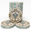A set of Gatsby Room casino-style ceramic poker chips on a clean white background, featuring a stack of round chips in the back, one chip in the front center, and two chips in the front row. The chips have a cream base with teal and gold geometric borders and a central diamond design.