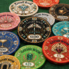 A collection of Gatsby Room casino Ceramic Poker chips in multiple colors including red, green, blue, pink, gold, and silver, arranged on a white background.