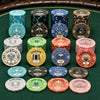 A set of Gatsby Room ceramic poker chips in multiple denominations and colors, neatly stacked and arranged on a green felt surface.