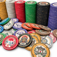 A collection of Senjutsu Card Room ceramic poker chips in stacks and piles on a white background, featuring various denominations and designs with Japanese-themed illustrations and text.