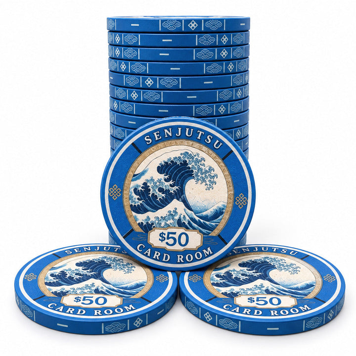 Stack of blue $50 Senjutsu Card Room ceramic poker chips arranged with one standing in the back and two lying in front, featuring a wave illustration inspired by Japanese art on a white background.