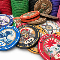 A collection of colorful Senjutsu Card Room poker chips in various denominations, including $5, $10, $20, and $100, arranged on a white surface with stacks of chips in the background.