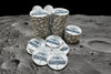 Stacks of 'Cratered' custom poker chips on a wooden surface with acrylic chip rack in background. 